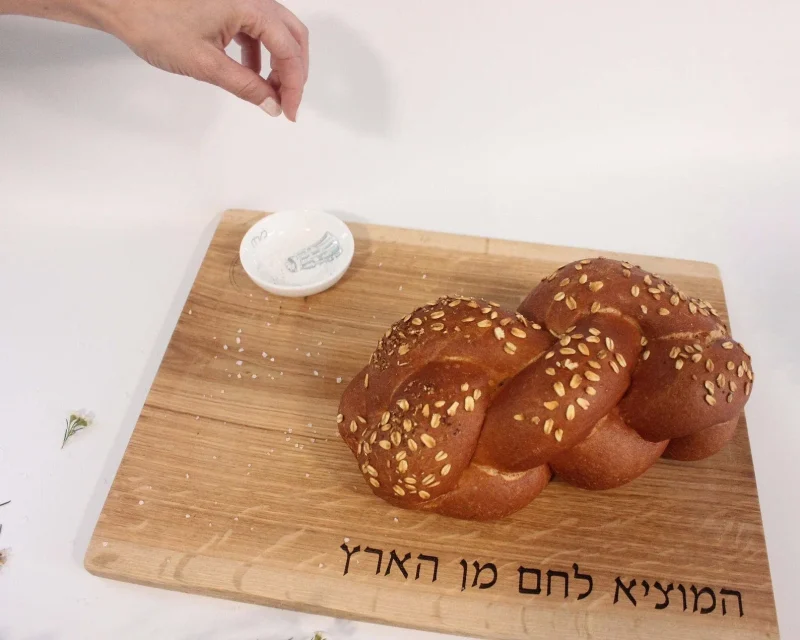 oak challah board with ceramic salt dish