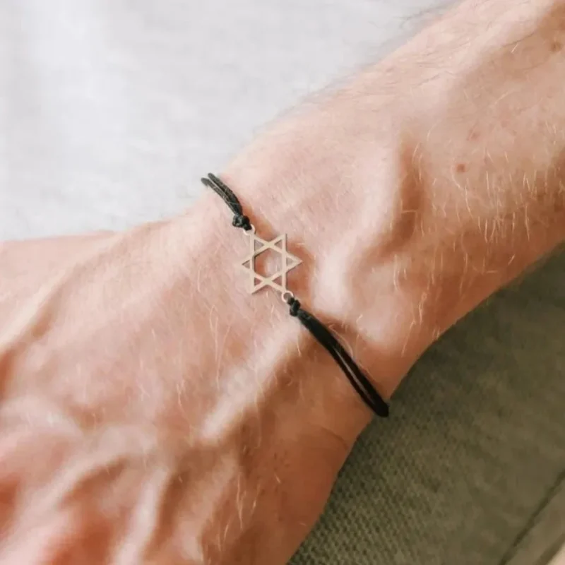 silver star of david bracelet on black cord 7 or 8