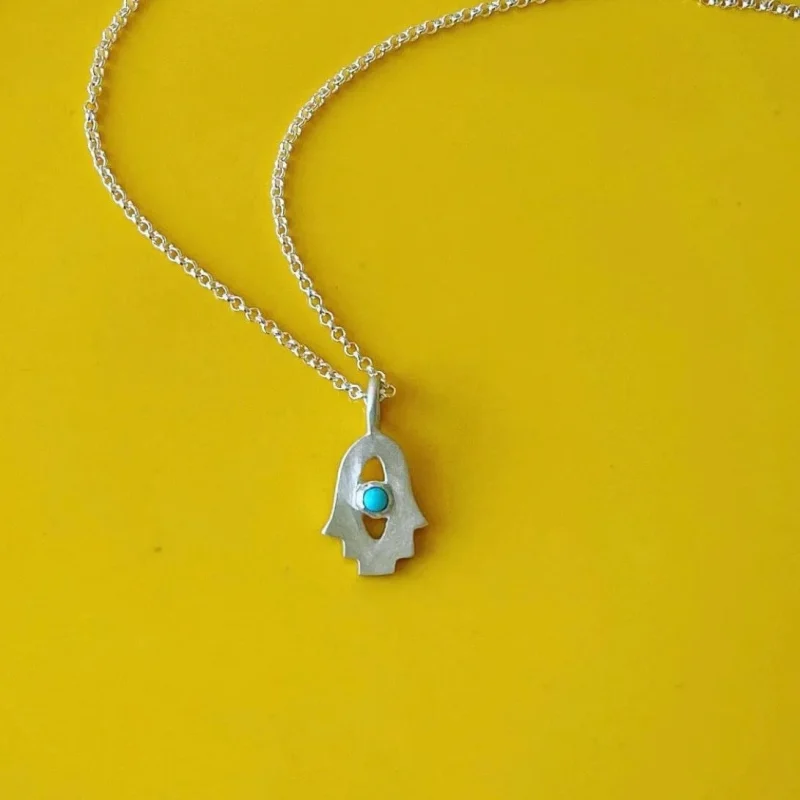 turquoise tiny hamsa amulet by emily rosenfeld